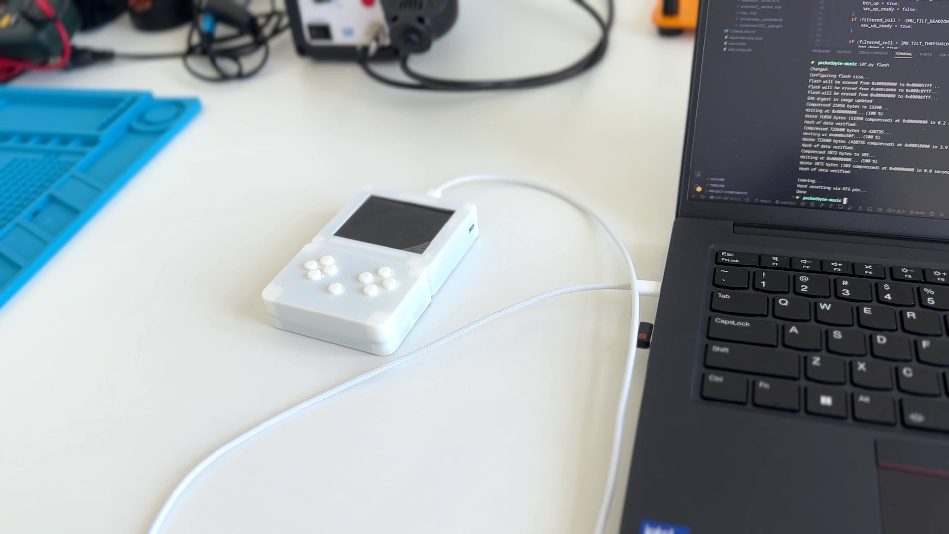 Pocketbyte connected to a laptop running code